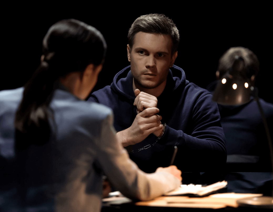 Stryders Criminal Defence Lawyers - Handcuffed man sitting at a table